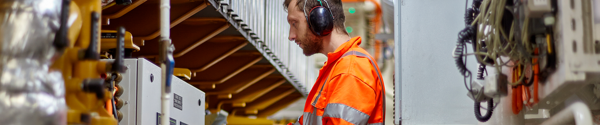 Estudante caminhando pelo campus segurando alças da mochila com suas mãos. 